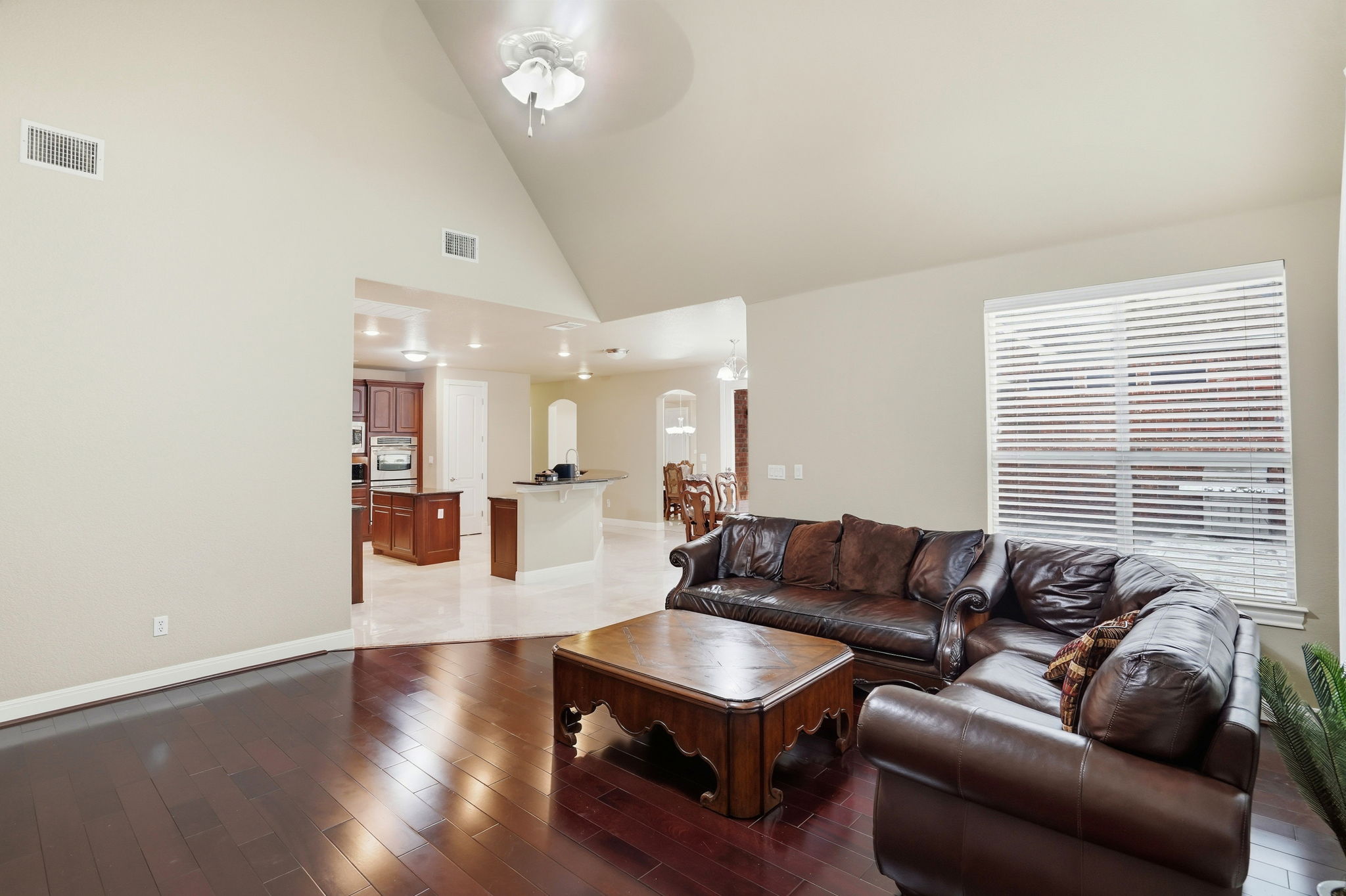 222 Vailco Lane Austin, TX 78738 - Photo 13 of 39 Living area with dark wood-finish flooring and a vaulted ceiling