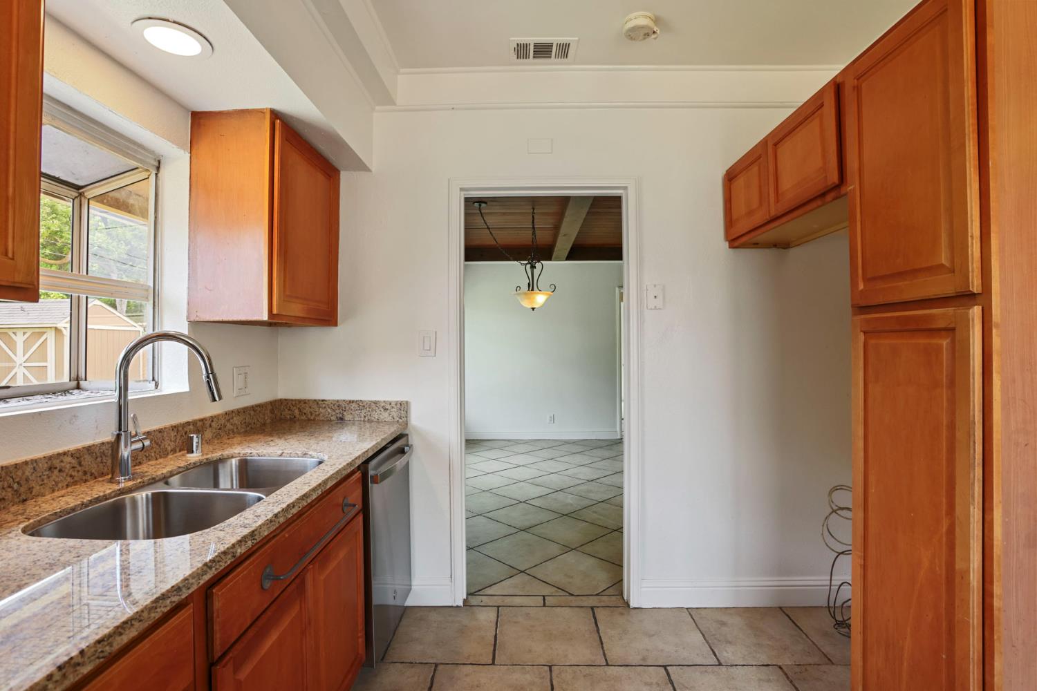 2452 Christina Avenue Stockton, CA 95204 - Photo 12 of 34 a kitchen with stainless steel appliances granite countertop a refrigerator and a sink
