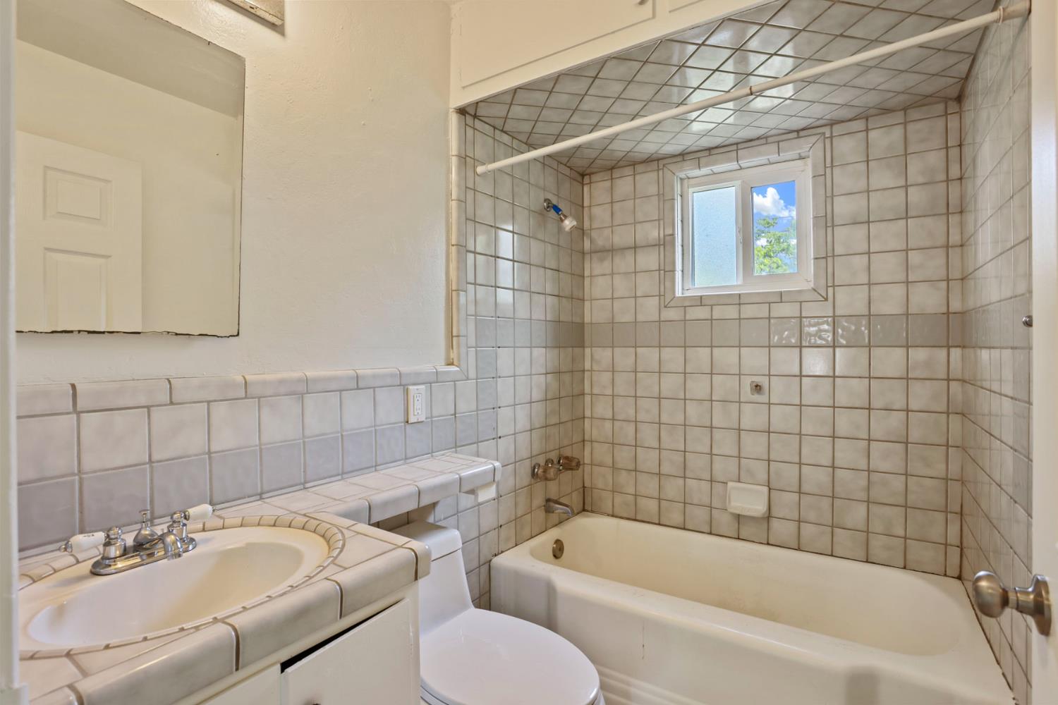 2452 Christina Avenue Stockton, CA 95204 - Photo 16 of 34 a bathroom with a sink toilet and bathtub