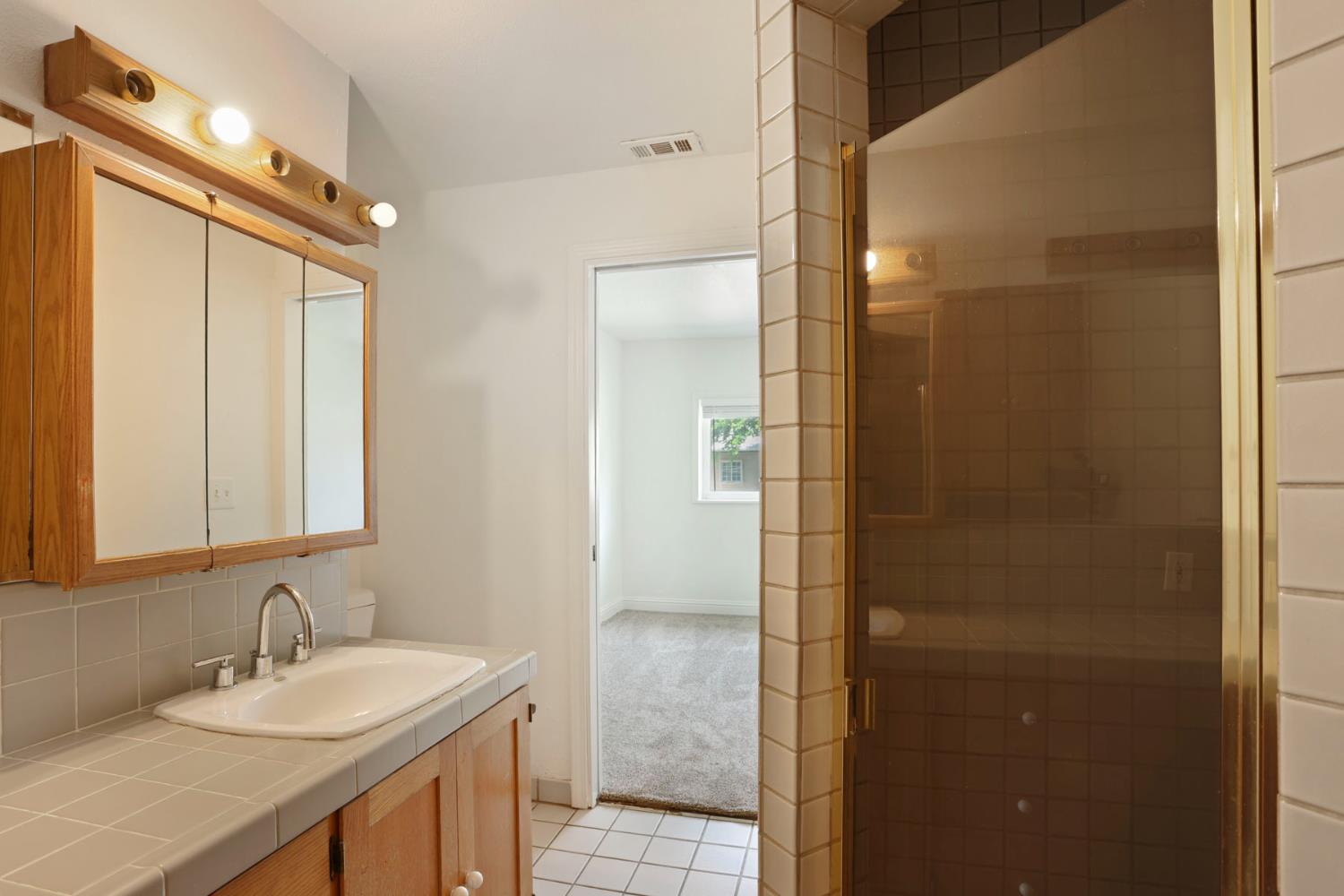 2452 Christina Avenue Stockton, CA 95204 - Photo 26 of 34 a bathroom with a sink and a mirror