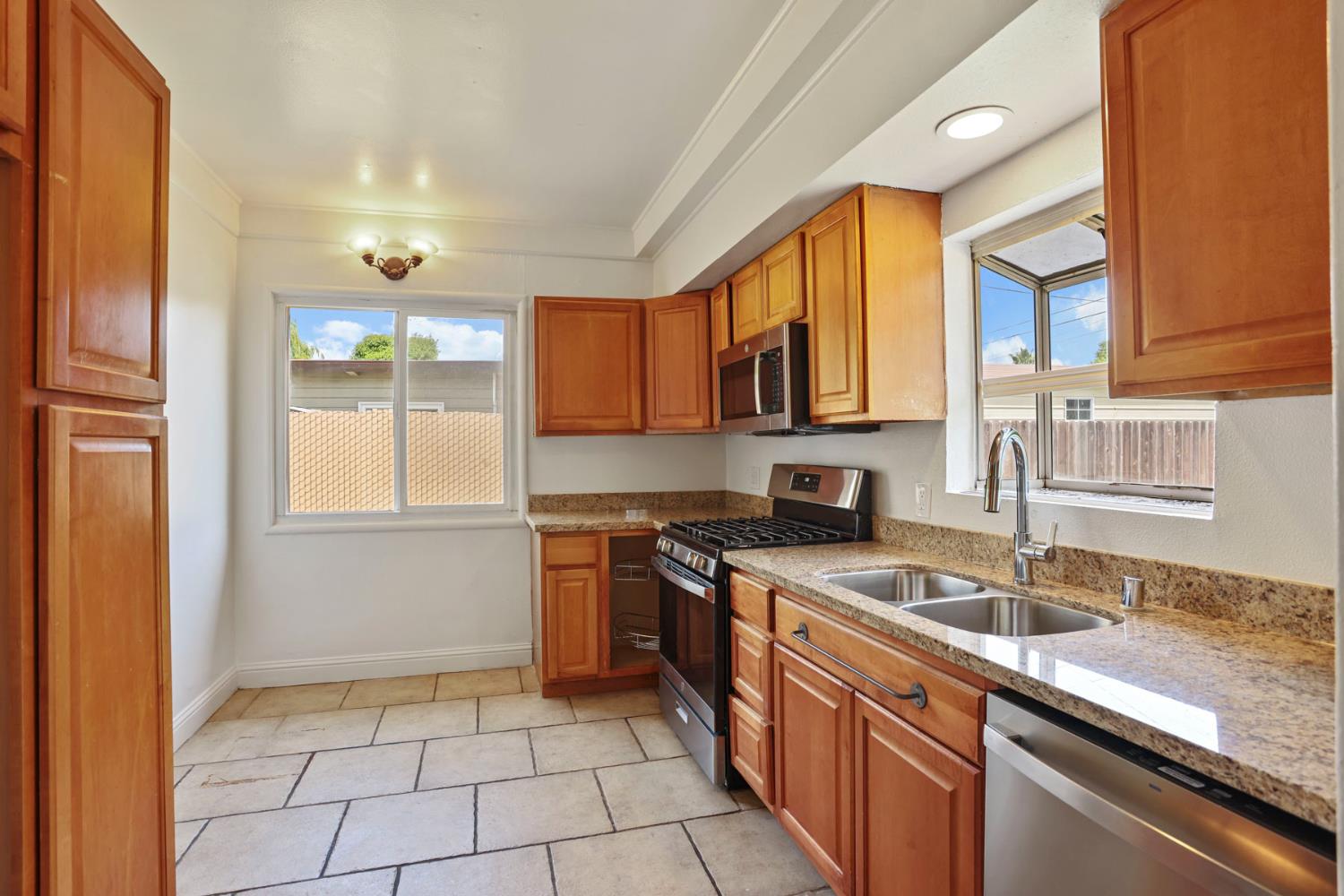 2452 Christina Avenue Stockton, CA 95204 - Photo 9 of 34 a kitchen with stainless steel appliances granite countertop a sink stove and cabinets