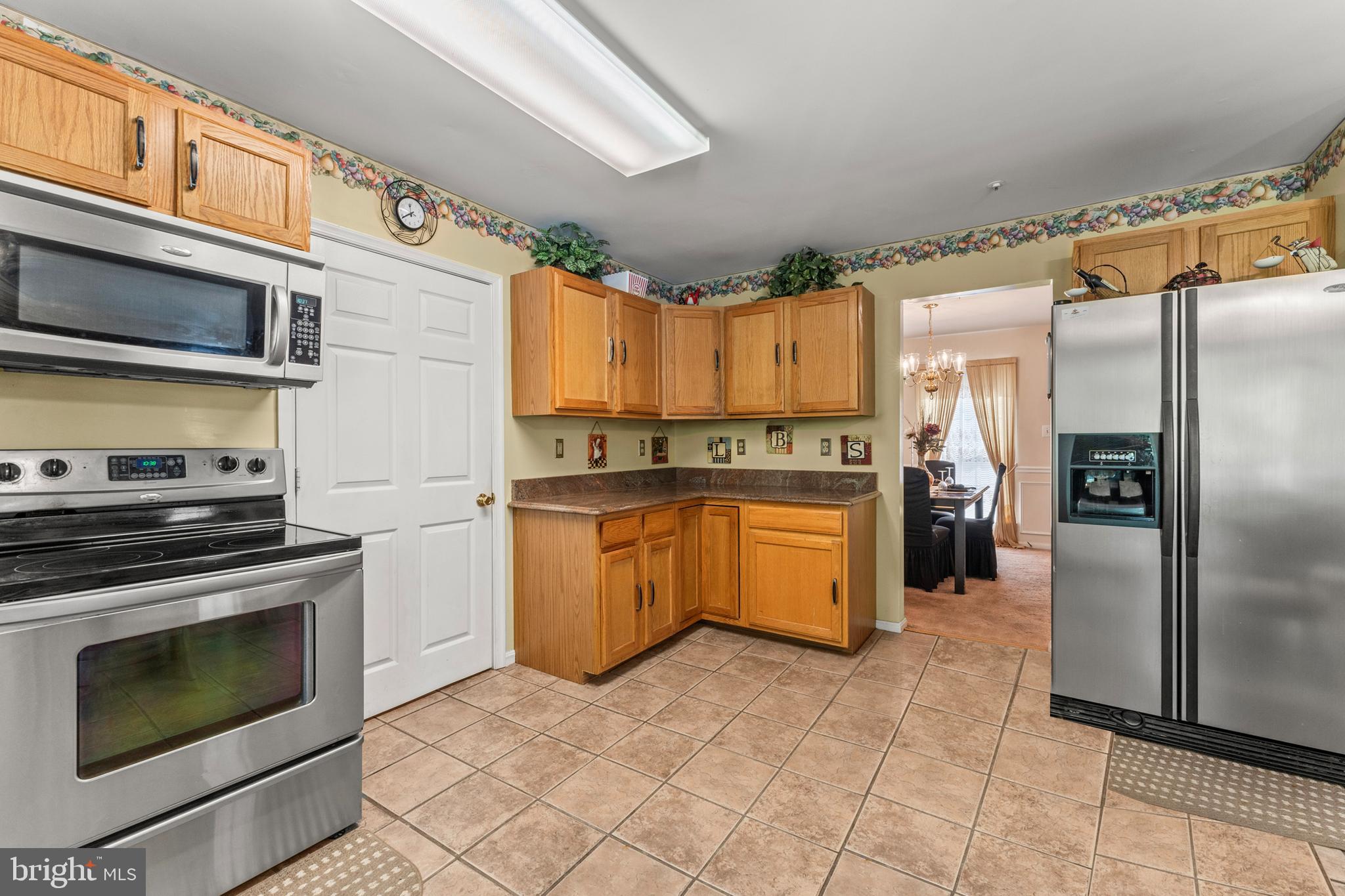 8910 Edison Lane Clinton, MD 20735 - Photo 20 of 51 a kitchen with a refrigerator sink and stove
