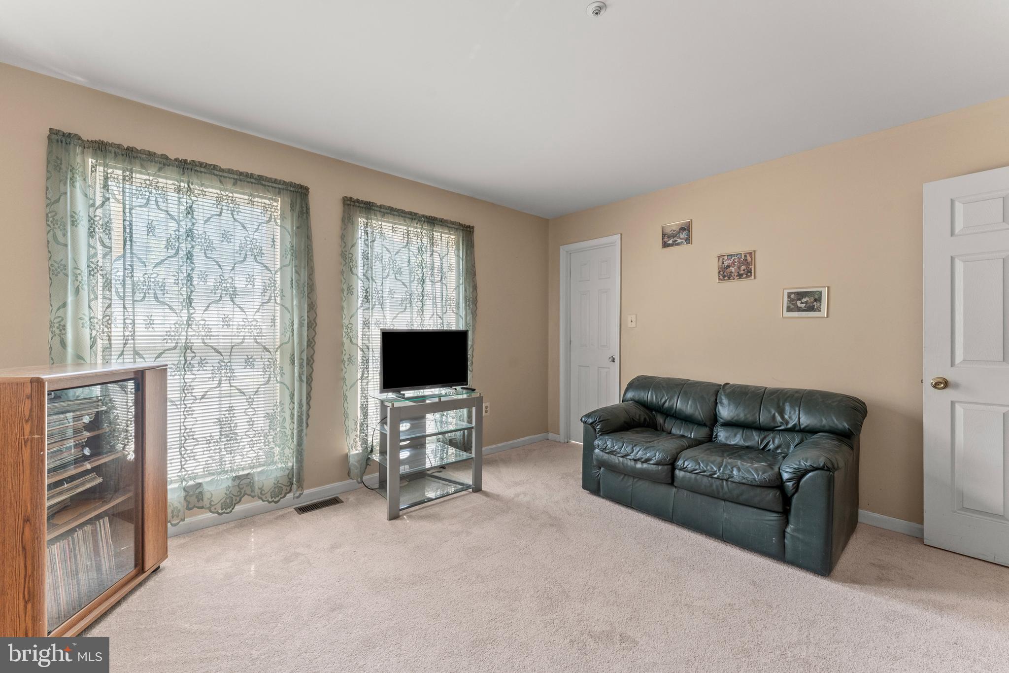 8910 Edison Lane Clinton, MD 20735 - Photo 22 of 51 a living room with furniture and a flat screen tv