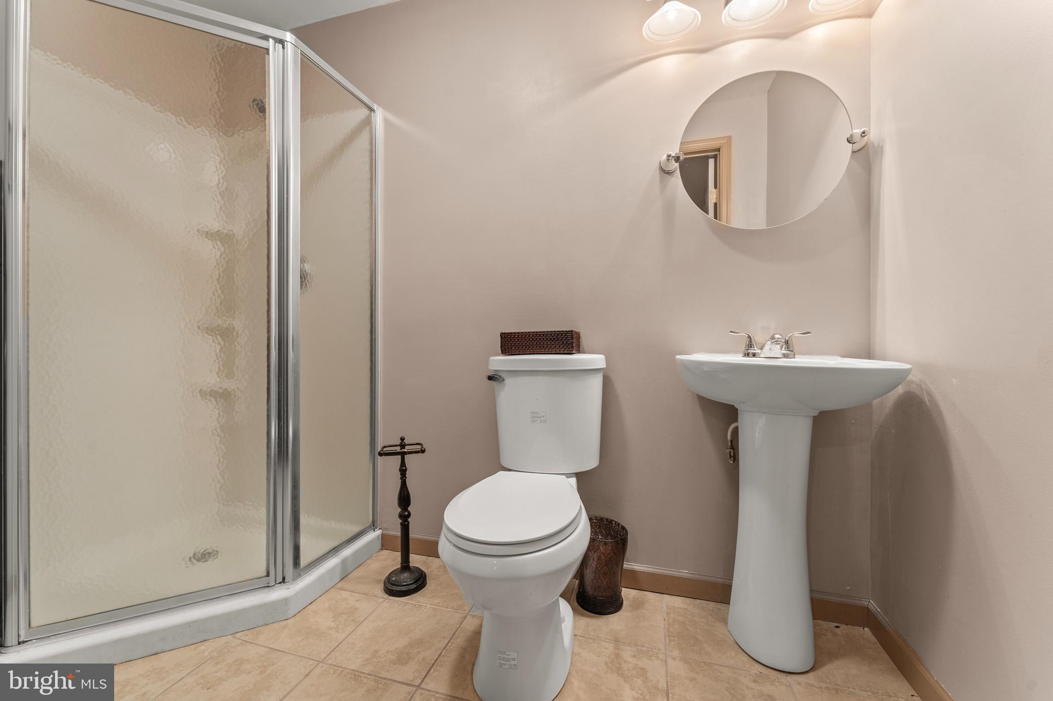 8910 Edison Lane Clinton, MD 20735 - Photo 40 of 51 a bathroom with a toilet a sink and mirror