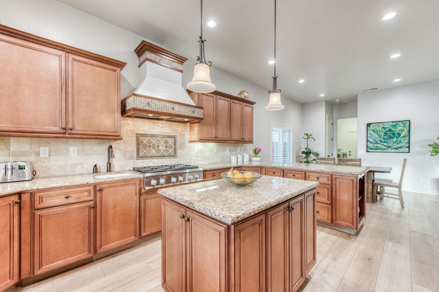 1674 North Cindy Avenue Clovis, CA 93619 - Photo 18 of 46 a kitchen with a sink a center island a counter space and a window