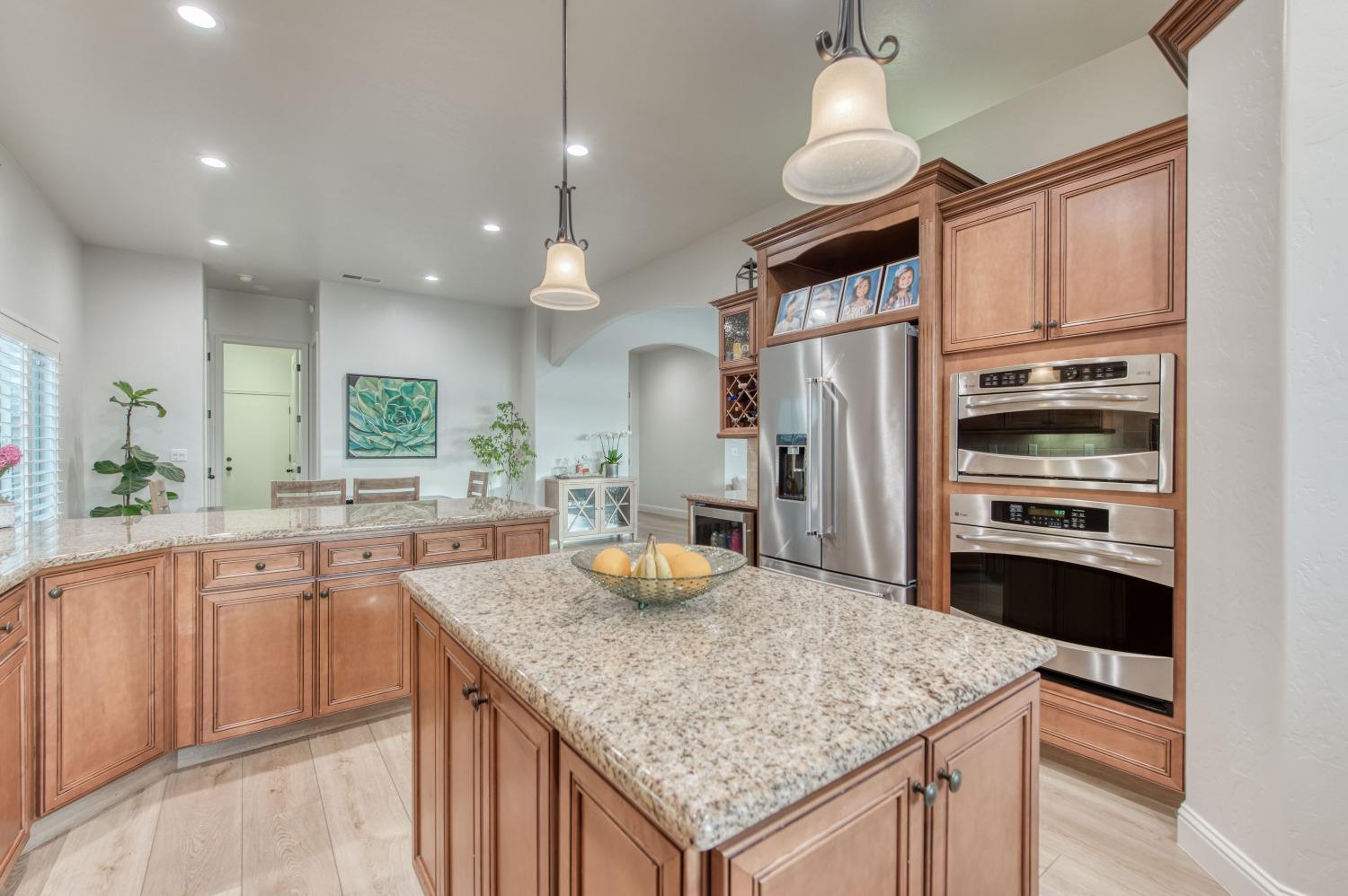 1674 North Cindy Avenue Clovis, CA 93619 - Photo 19 of 46 a kitchen with stainless steel appliances granite countertop a sink refrigerator and cabinets