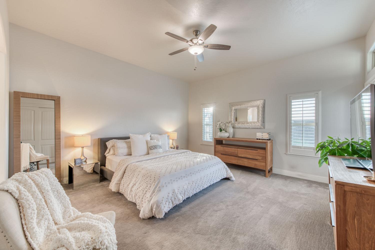 1674 North Cindy Avenue Clovis, CA 93619 - Photo 27 of 46 a bedroom with bed and a chandelier