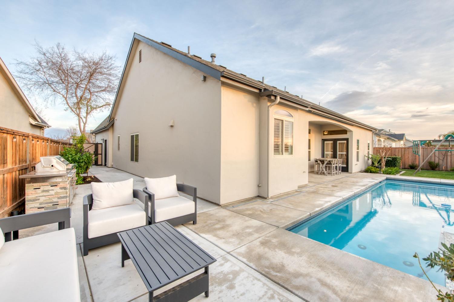 1674 North Cindy Avenue Clovis, CA 93619 - Photo 35 of 46 a front view of house with yard outdoor seating and barbeque oven
