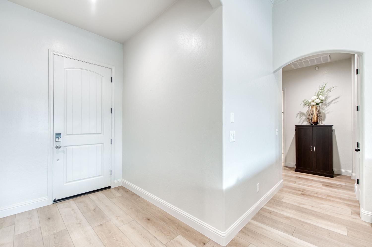 1674 North Cindy Avenue Clovis, CA 93619 - Photo 9 of 46 a view of a hallway with wooden floor and a bathroom