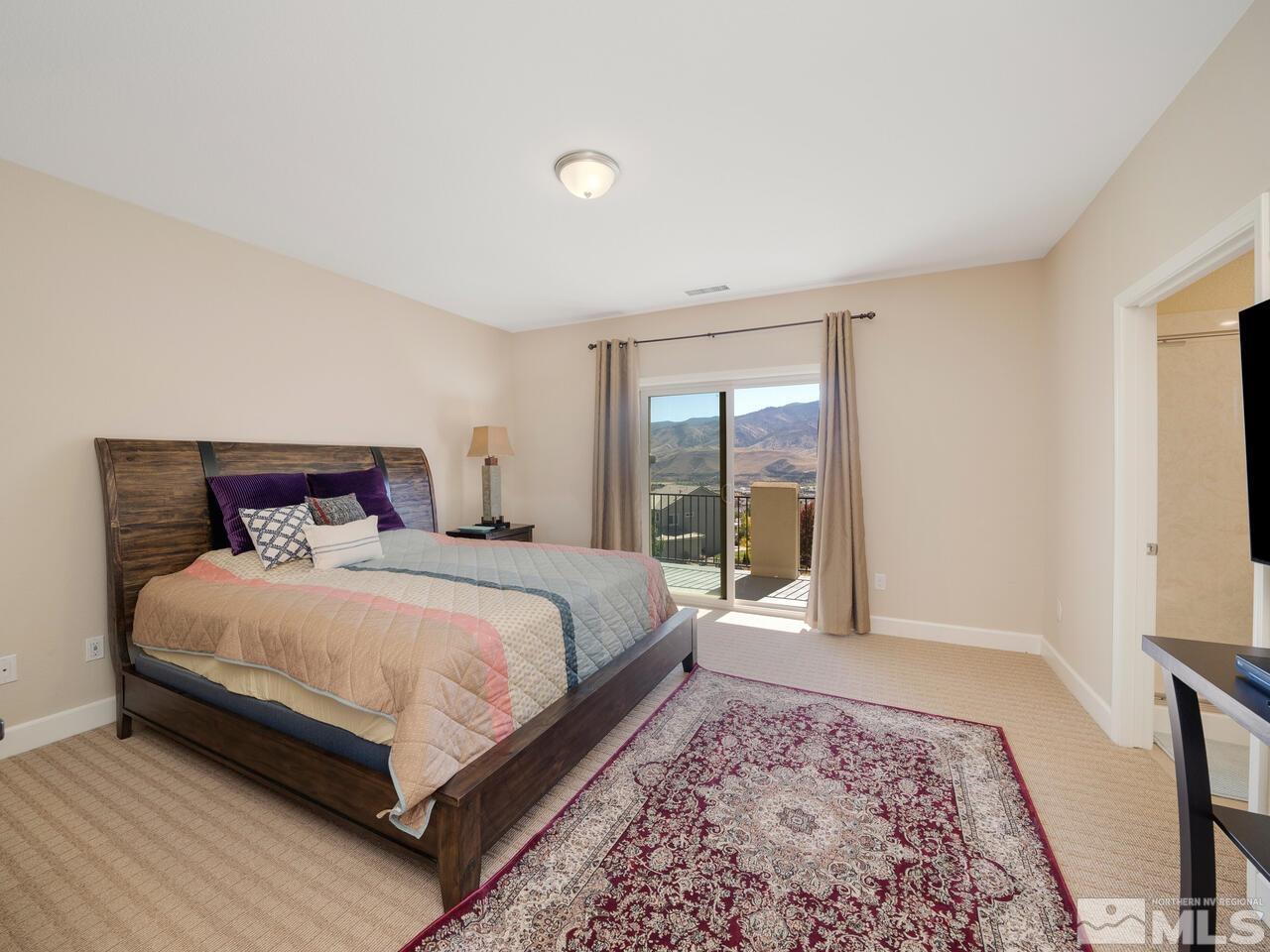 9050 Sydmesa Drive Reno, NV 89523 - Photo 12 of 23 a bedroom with a large bed and a large window