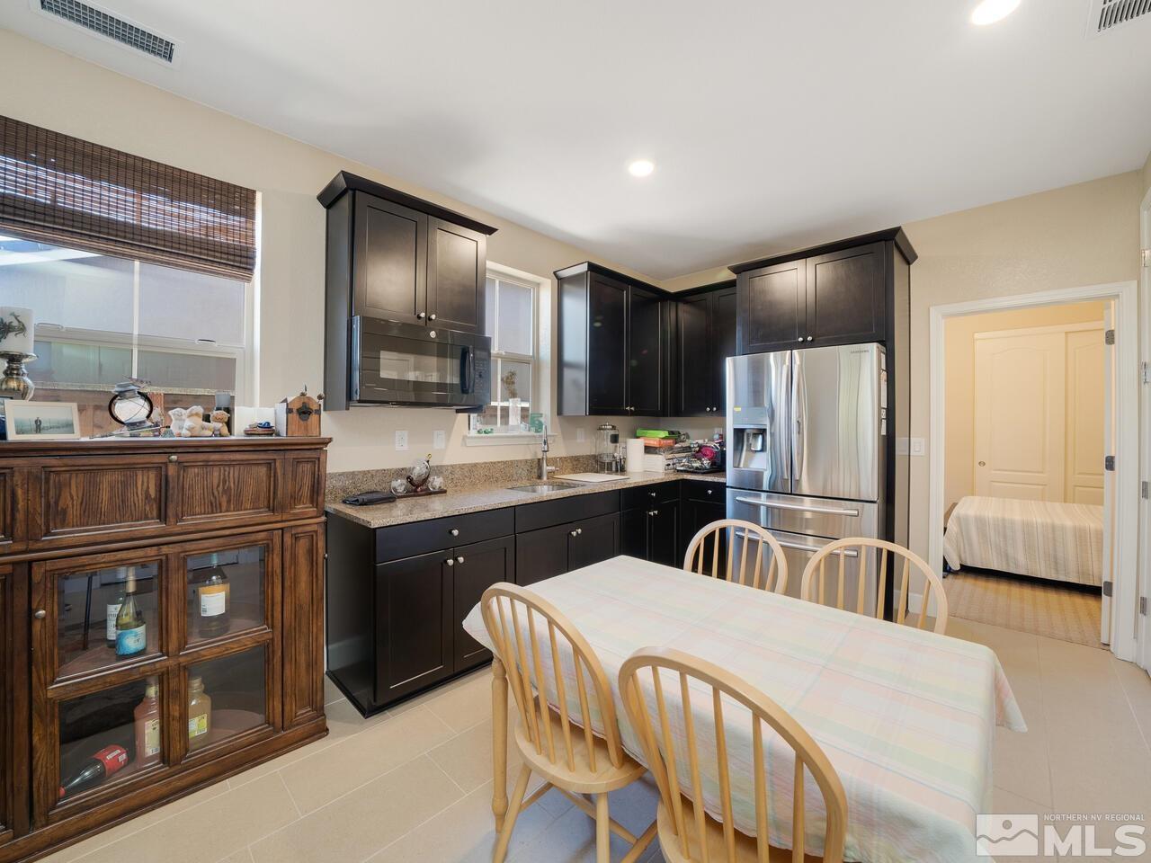 9050 Sydmesa Drive Reno, NV 89523 - Photo 19 of 23 a kitchen with refrigerator cabinets and a counter top space