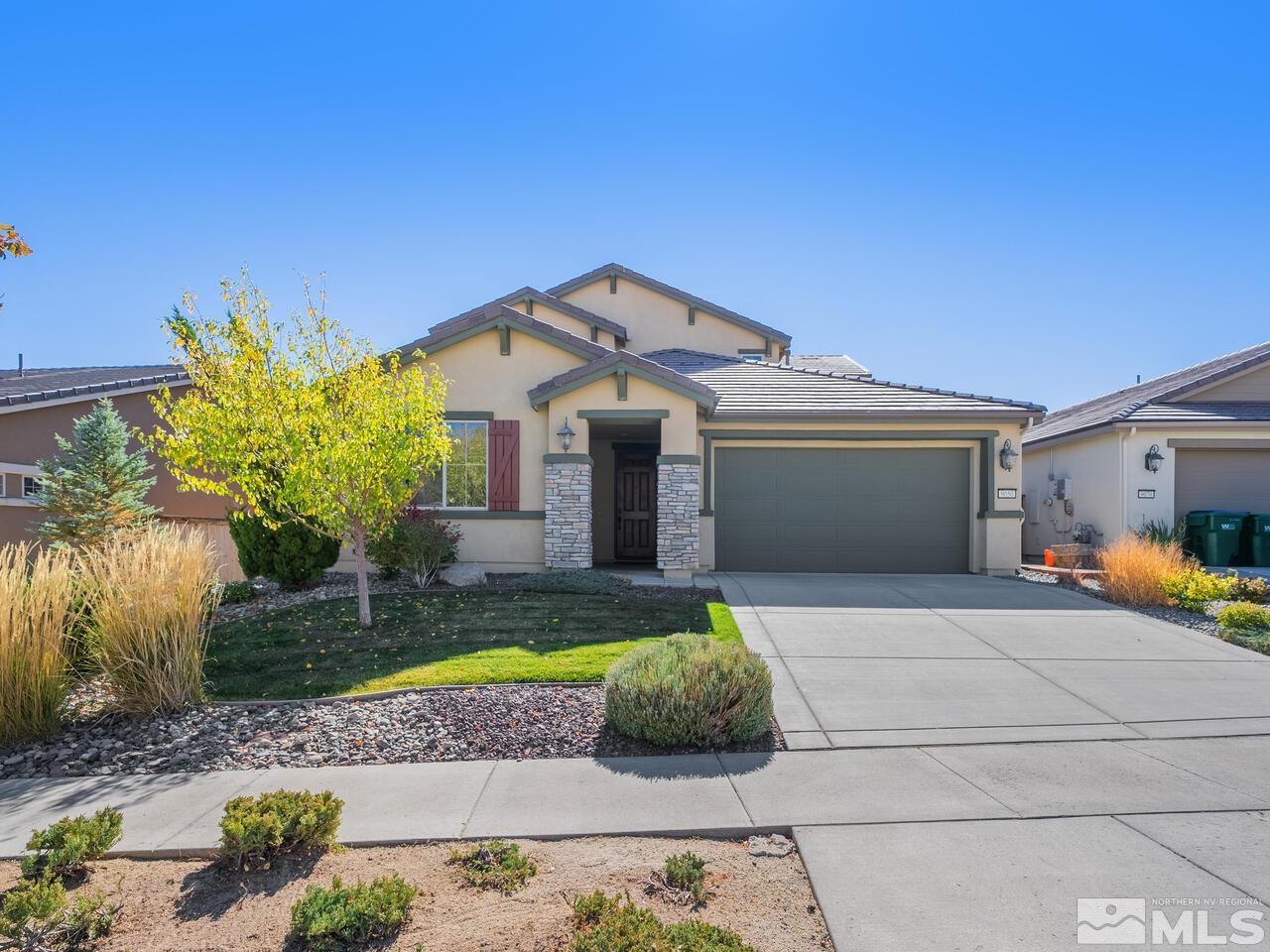 9050 Sydmesa Drive Reno, NV 89523 - Photo 22 of 23 a front view of a house with a yard and garage