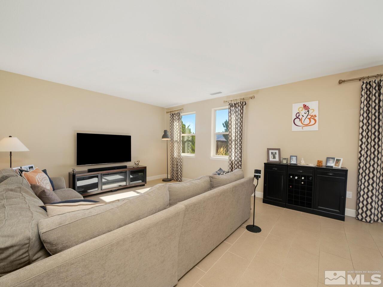 9050 Sydmesa Drive Reno, NV 89523 - Photo 6 of 23 a living room with furniture and a flat screen tv