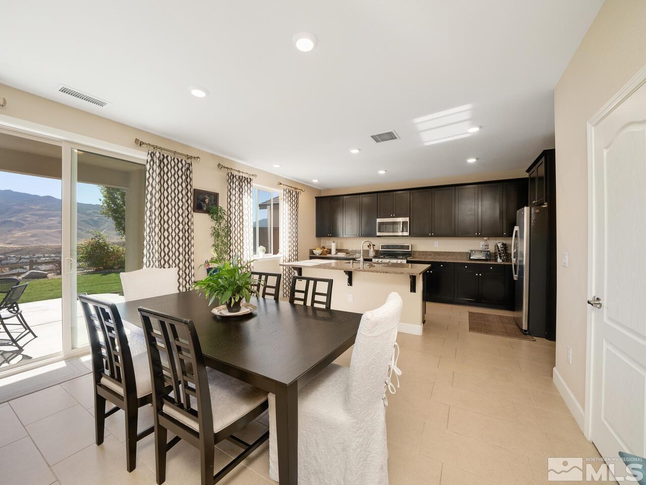 9050 Sydmesa Drive Reno, NV 89523 - Photo 7 of 23 a kitchen with a table and chairs in it