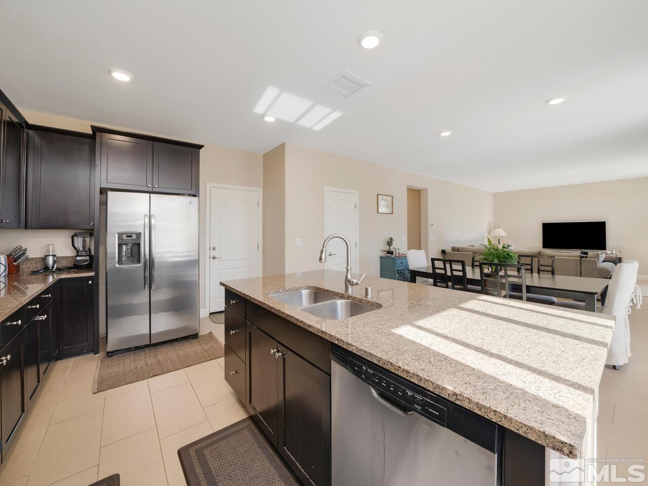 9050 Sydmesa Drive Reno, NV 89523 - Photo 9 of 23 a large kitchen with granite countertop a large counter top stainless steel appliances and cabinets