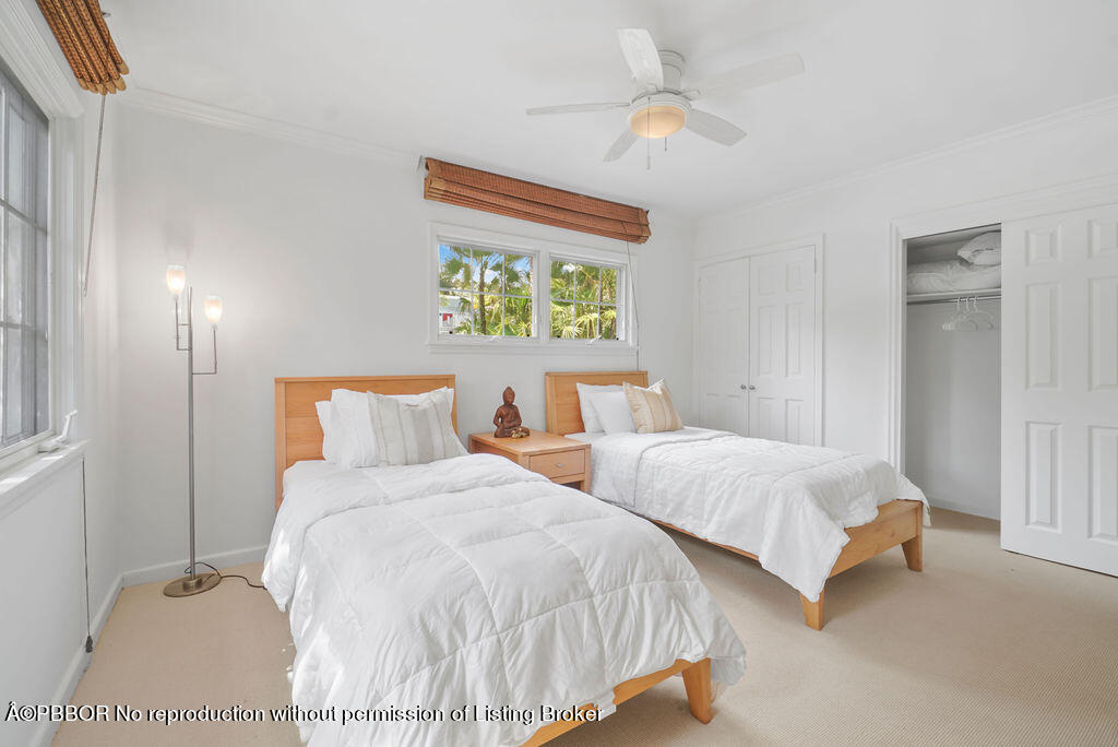 257 Fairview Road Palm Beach, FL 33480 - Photo 12 of 30 a bedroom with two beds and a chandelier
