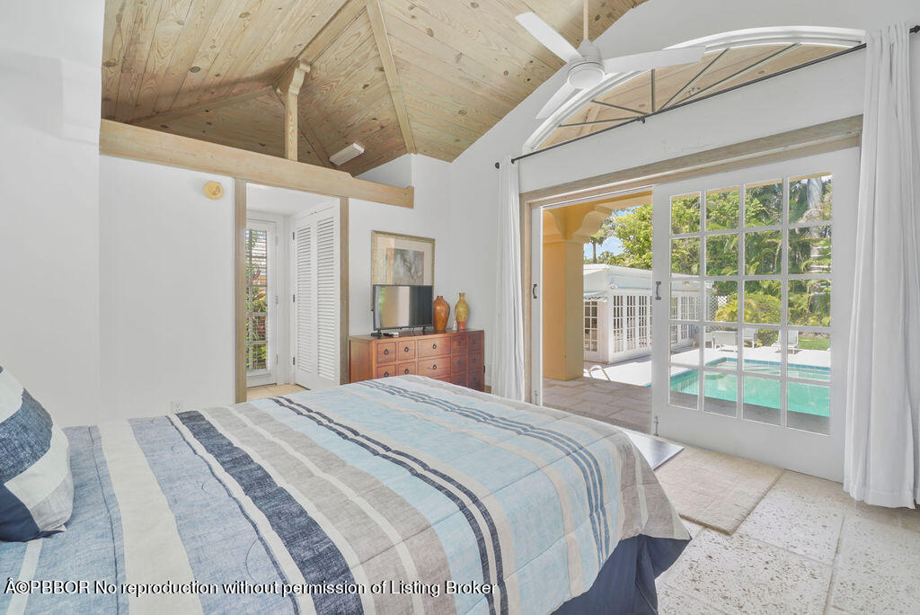 257 Fairview Road Palm Beach, FL 33480 - Photo 21 of 30 a bedroom with a large bed and a large window