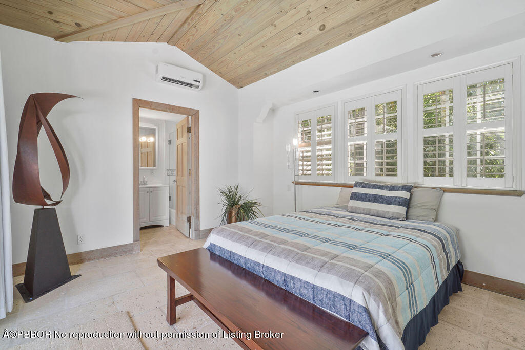 257 Fairview Road Palm Beach, FL 33480 - Photo 22 of 30 a spacious bedroom with a bed a dresser with wooden floor