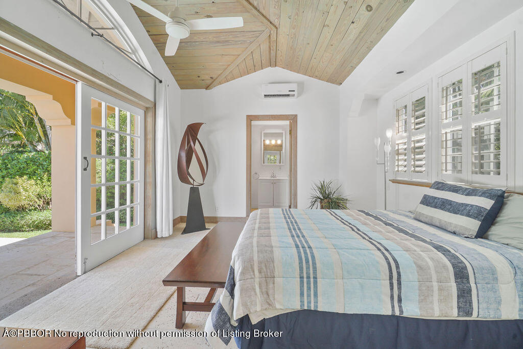 257 Fairview Road Palm Beach, FL 33480 - Photo 23 of 30 a bedroom with a large bed and a window