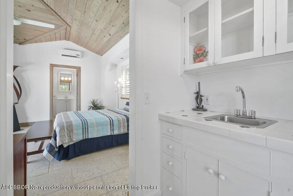 257 Fairview Road Palm Beach, FL 33480 - Photo 24 of 30 a spacious bedroom with a bed and cabinet