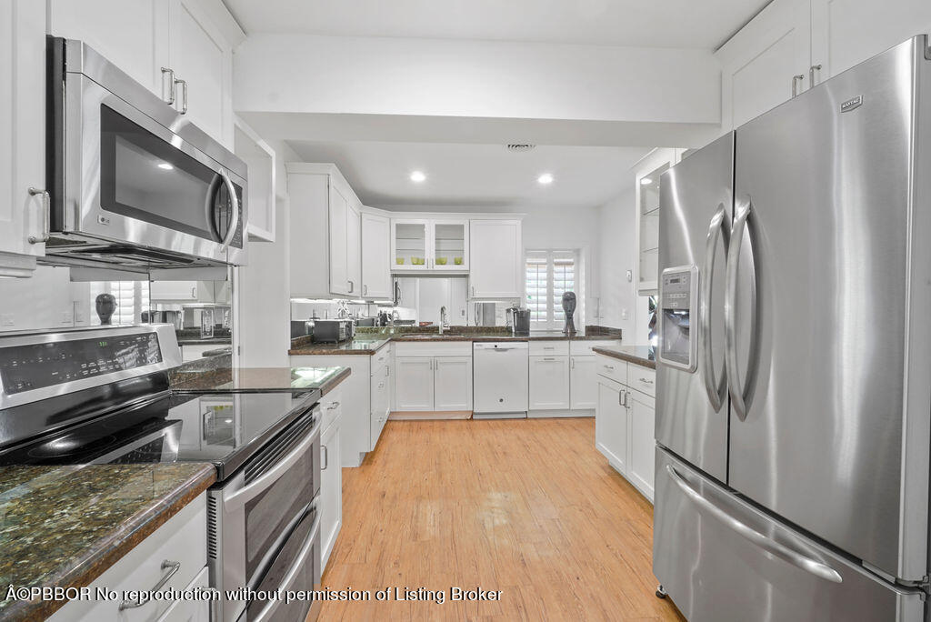 257 Fairview Road Palm Beach, FL 33480 - Photo 6 of 30 a kitchen with stainless steel appliances granite countertop a refrigerator stove and sink