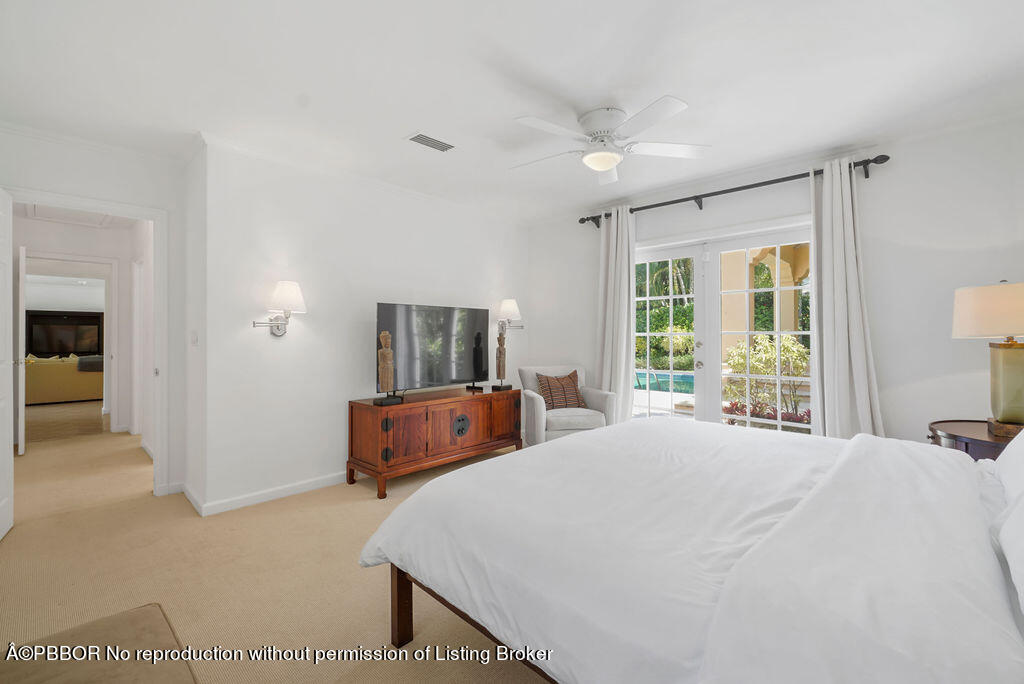257 Fairview Road Palm Beach, FL 33480 - Photo 9 of 30 a bedroom with a large bed and a couch