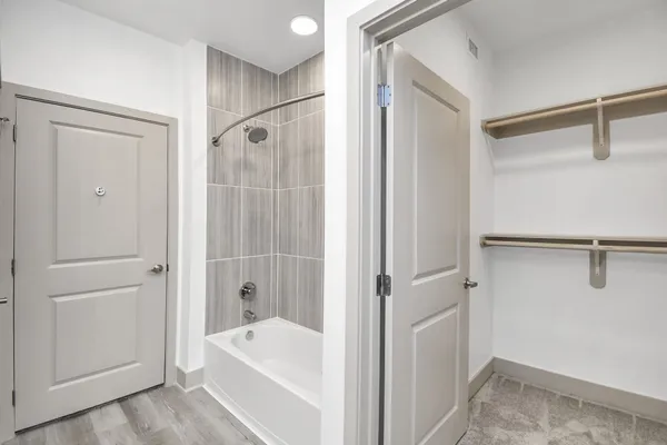 a bathroom with a bathtub and a shower