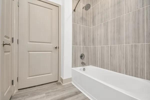 a bathroom with a bathtub and shower