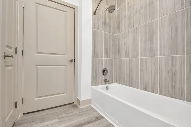 a bathroom with a bathtub and shower