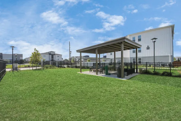 a view of a house with a big yard and a fountain