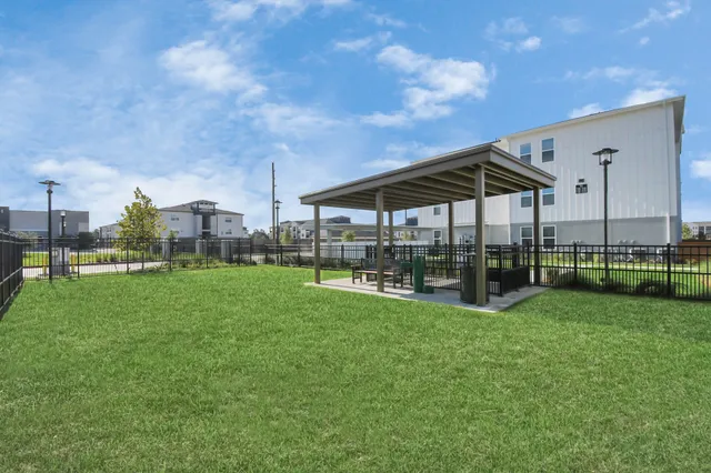 a view of a house with a big yard and a fountain