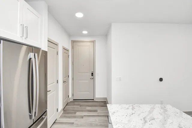 a view of a big room with wooden floor and a hallway