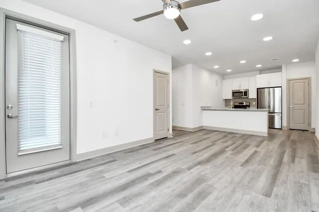 a view of kitchen with refrigerator and window