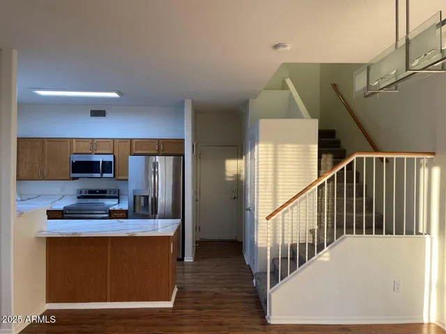 a view of a living room with furniture and wooden floor