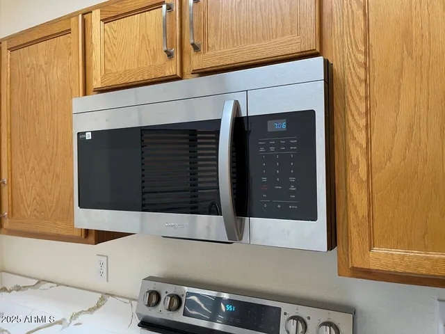 a metallic refrigerator freezer sitting in a kitchen