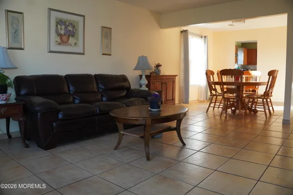 a living room with furniture a dining table and a dining table with wooden floor