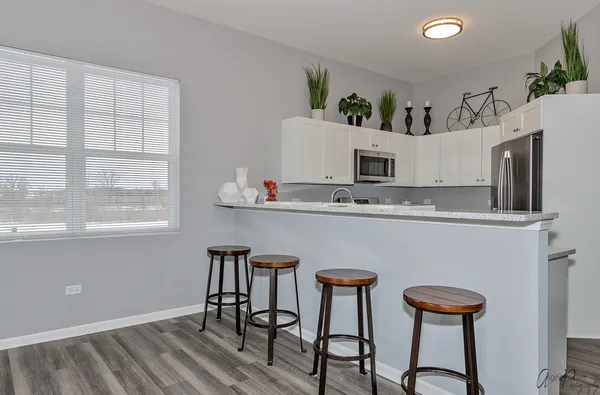 a kitchen with stainless steel appliances granite countertop a stove a sink refrigerator and a microwave