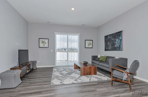 a living room with furniture window and wooden floor