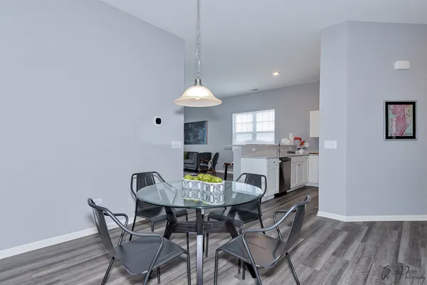 a view of a dining room with furniture and wooden floor