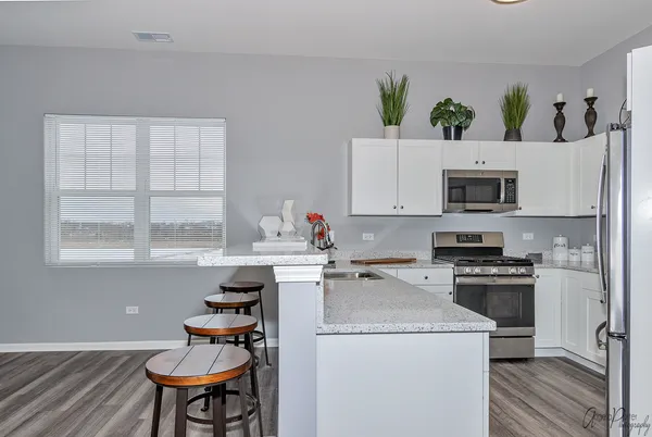 a kitchen with appliances a sink and cabinets
