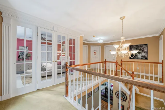 a view of an entryway wooden floor and chandelier