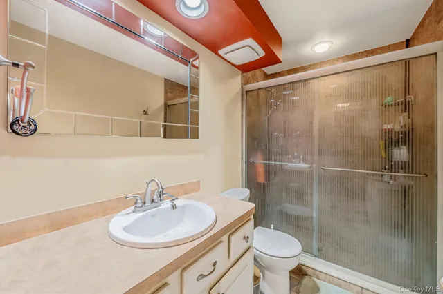 a bathroom with a sink toilet and shower