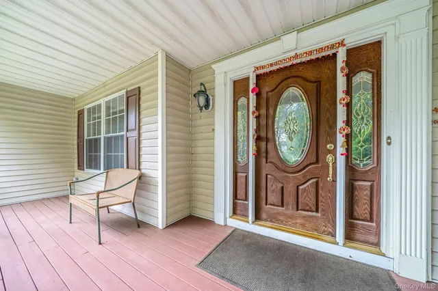 a view of a house with entryway and wooden fence