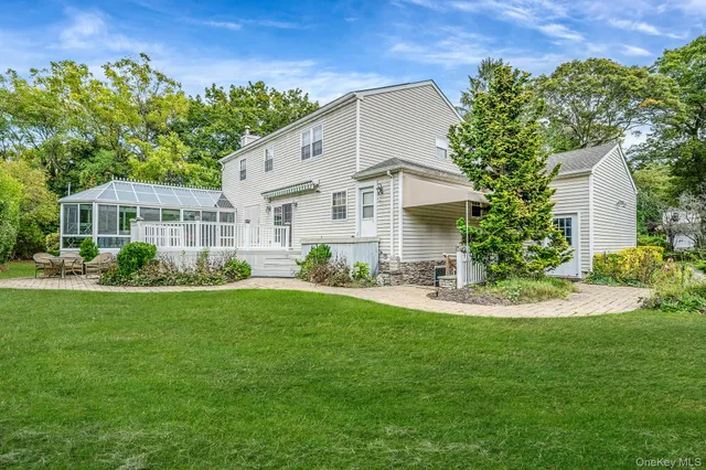 a front view of a house with a yard table and chairs