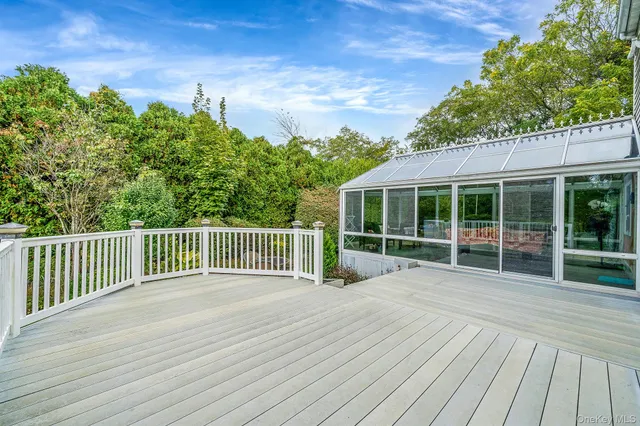 a view of a house with a wooden deck