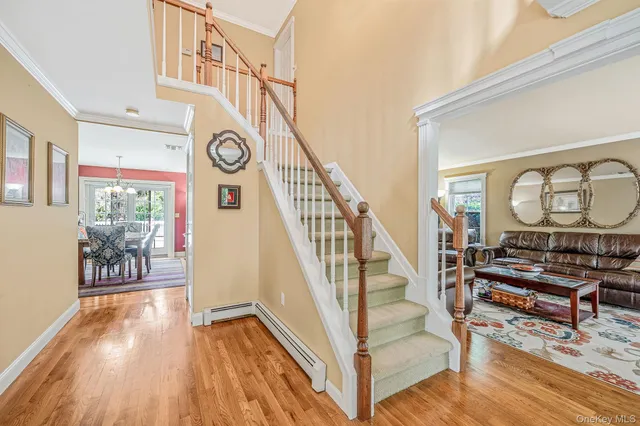 a view of entryway livingroom and hall with wooden floor