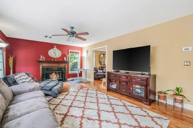 a living room with furniture a flat screen tv and a fireplace