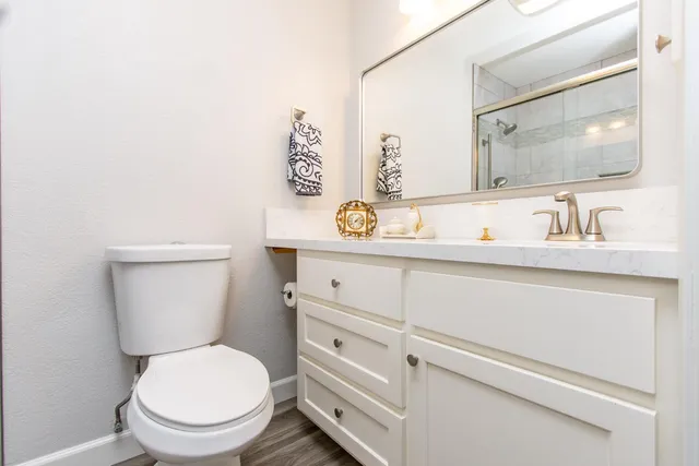 a white toilet sitting next to a bathroom