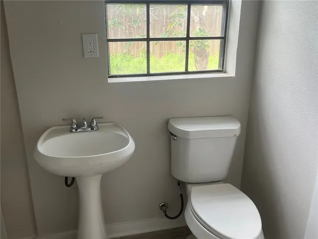 a white toilet sitting next to a bathroom sink