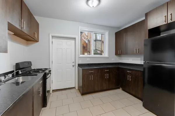 a kitchen with a refrigerator stove and cabinets